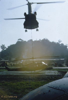 CH-47 slinging UH-1D
John Keller Photo

Golf Course, 15th TC pad. A CH-47 from the 228th slinging in a broke UH-1D. Looking over the nose of 64-13740, September 1966.

