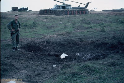 Chucky Seitz beside rocket crater on flightline.
Bob Kelly Photo
