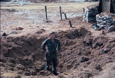 Russian 122 rocket crater
Bob Kelly Photo

D/227. Camp Evans. Another Russian 122 rocket crater. Threw lots of dirt on tents. It was our good fortune that this rocket had a delay fuse. We were in my bunker fifty feet away.

