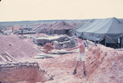 Filling the hole
Bob Kelly Photo

D/227. Camp Evans. Time to fill it in. The CO not happy.
