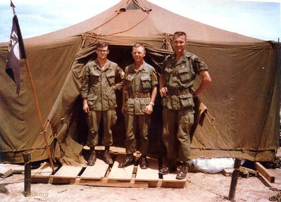 Headquarters A/227
Photo from Mrs. Petersen

Left to Right: Probably the Company Clerk, First Sergeant, Major Darwin "Pete" Petersen
Early 1968 at Camp Evans

