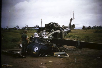 Fife's huey destroyed at An Khe 1965
Dennis Boerner Photo
C/227, 1965

William Fife, D/227, served as a crew chief of UH1B 62-12543 and later UH1B 64-14181 stationed at Camp Radcliff at An Khe

A photo of the ship that slung a rotor blade on the flight line that morning so long ago.  Thanks to Capt Dennis Boerner C/227 Aviator for saving the picture.  Never thought I would find one.  Len Bauer, Co D 227th Vietnam 1965

Probably UH-1B tail number 64-14052 that is listed as a loss to inventory on 12/02/1965 

