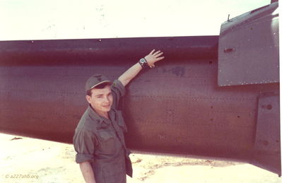 Dennis Howell with finger in bullet hole (possibly aircraft #064) 
Dennis Howell Photo

