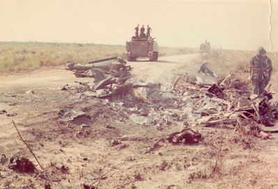 Results of mid-air
Ron Dillard Photo

The burned aircraft are the results of a mid-air that I was involved investigating. One ship cut the mast off the other during a close 2 ship formation. 
