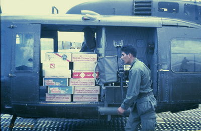  What can a Huey haul? A Pallet and a half of beer a soda!!! 
JP Edwards Photo

Individual pictured identified as Ray Ynostroza (by Wayne Driver)

