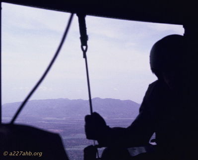 Door Gunner
Bob Kelly Photo

Gun ship door gunner. M-60 hangs off of a bungee cord.
