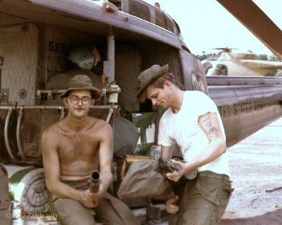 Terry Moore and LaFrancouis
Joe Parnal Photo

From Terry Moore: On the left ,with goofy look on face, is me, "Ozark Joe" (Terry Moore) with my gunner Frenchie (LaFrancouis).
We were loading the aircraft to go to Camp Holloway. Notice the mattress rolled-up behind me.
