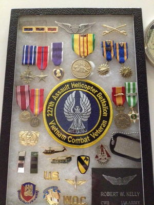 Display Case 2
Robert Kelley Photo

These are three different displays, one for each grand child. I wanted each different. The wings and medals remain at the top for each but anything goes after that. The Huey & Hook, Pouvoir and Garry Owen were all there.  I am mixing a few different items in for each child.
