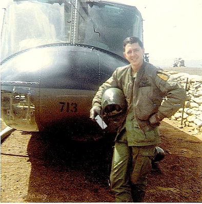 Mike Dubberly
Tommy Harrison Photo

Identified by his daughter as SP5 Gordon Lewis, A/227. 1966-1968, Door Gunner.

Previously identified as:
WO Mike Dubberly, Aug 67 to Aug 68 in front of UH-1H, 66-16713. When the new "H" models arrived in late Aug 67 the Original "Pouvoir" insignia was not added.
