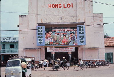Phan Thiet Movie Theater
Bob Kelly Photo

Lots of movie goers there judging by all the bikes. Banner shows sexy girl, dressed chimp with bell, baby on blanket on grass under tree, western man (French?) with silver sword and gold shield.
