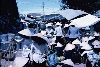 Market using cloth sun shields
Bob Kelly Photo

Lady with two baskets connected to wood shoulder carrier.

