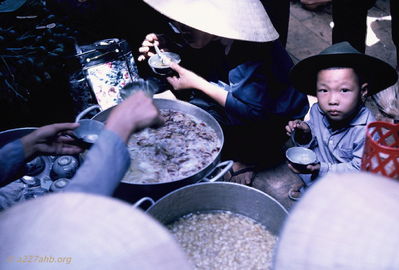 Fish soup and bean soup
Bob Kelly Photo

Phan Thiet Market. Large fish soup and large bean soup. Little boy eating small bowl of soup.

