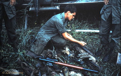 Arms Cache 
Jerry Westenskow Photo

Collecting arms after a battle.  Wayne Driver identified the individual in the photo as Lee King.
PhanThiet

