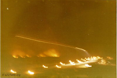 Night Landing at Lai Khe
With the aperture open this photo is an aircraft landing. You can see when he turned on the landing light both in flight and as it appears on the runway. The runway lights were artillery canisters buried alongside the runway filled with JP-4 and lit. The fire in the back ground was from a previous fire fight.

Richard Gilkey photo. 
August - October 1970
